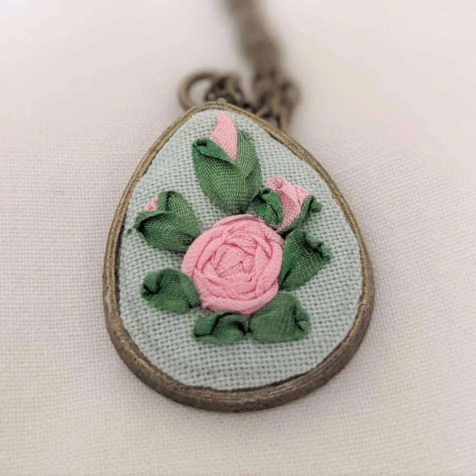 Embroidered roses teardrop pendant
